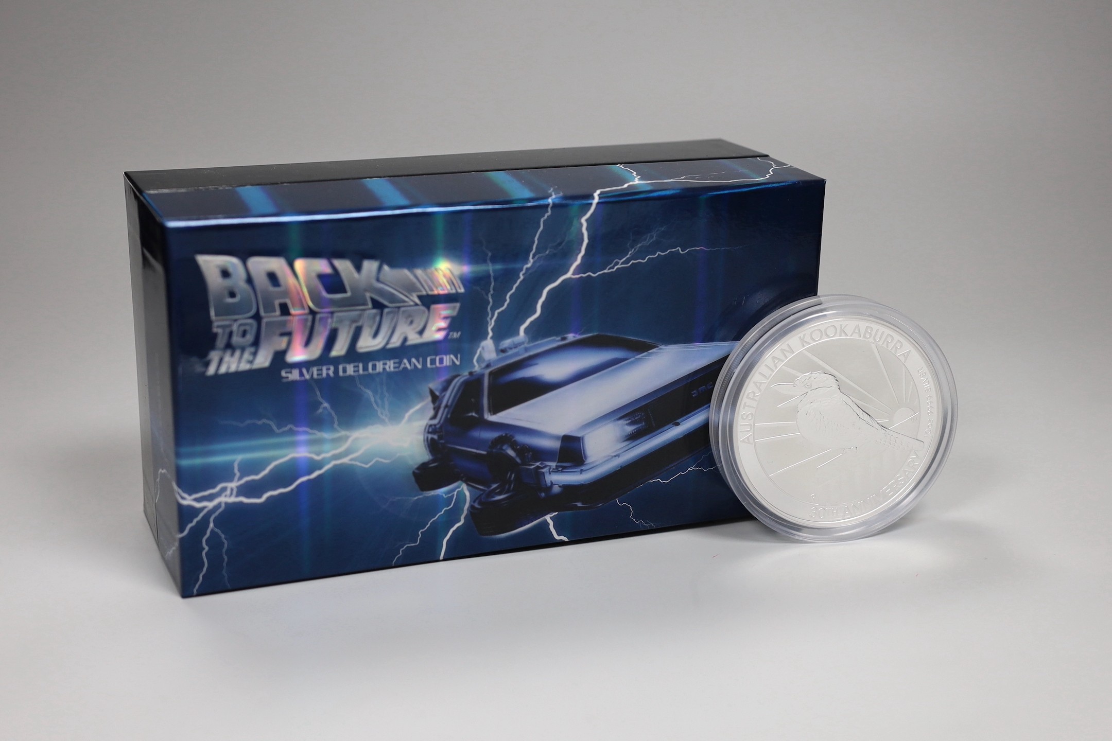 A Back to the Future DeLorean silver coin and model car set and an Australia mint 10oz bullion silver $10